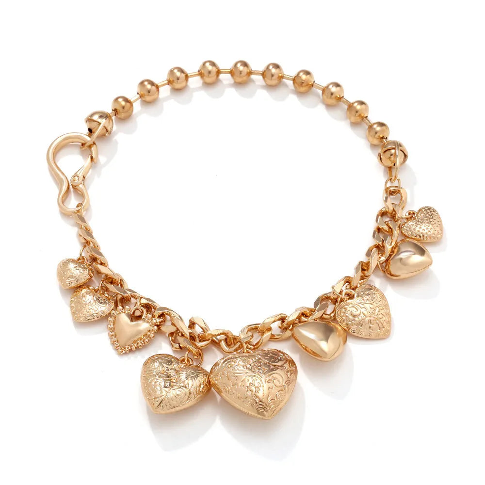 Gold women's necklace with a large, exaggerated heart-shaped pendant on an adjustable chain.