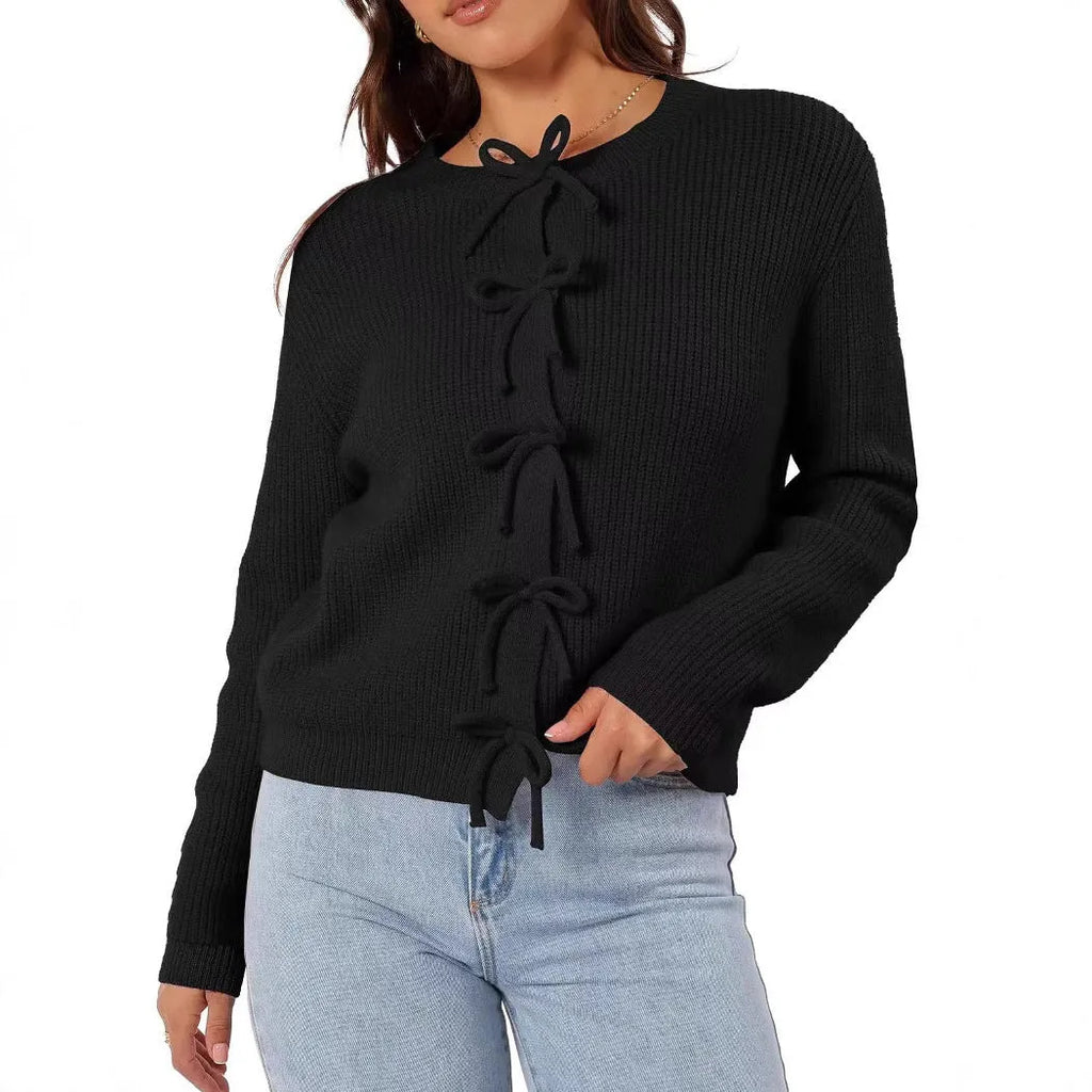 Women's long sleeve knitted cardigan with bow pattern in loose fit, available in multiple colours, shown on model