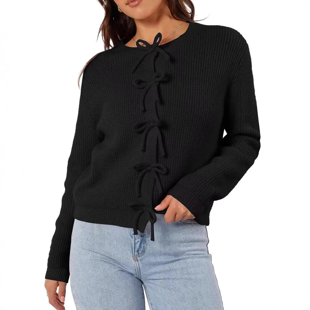 Women's long sleeve knitted cardigan with bow pattern in loose fit, available in multiple colours, shown on model