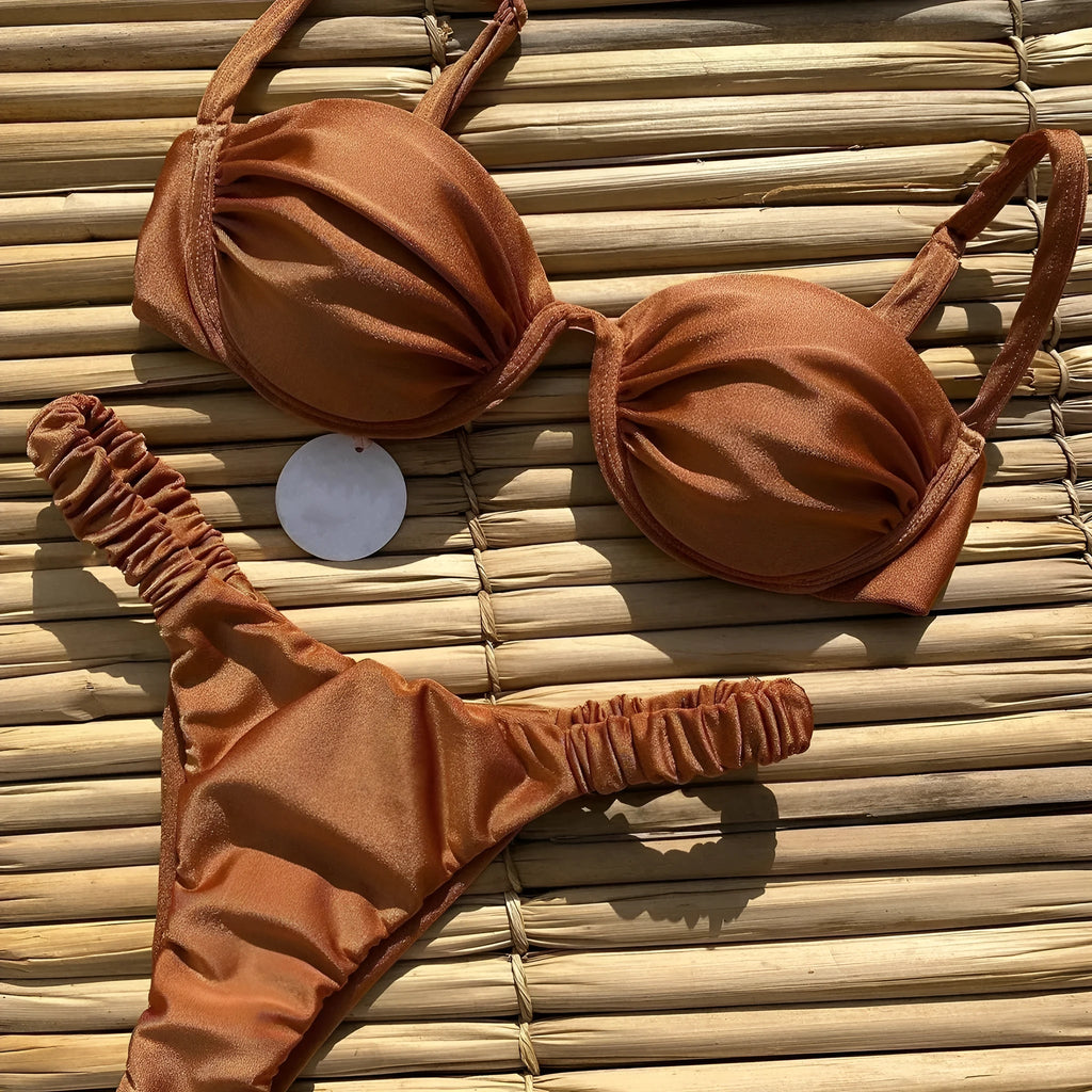Women's black underwire bikini swimsuit with triangle top and briefs bottom on a mannequin.
