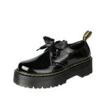Black women's thick soled lace-up shoes with a cross-strap and ribbon detail on the front.