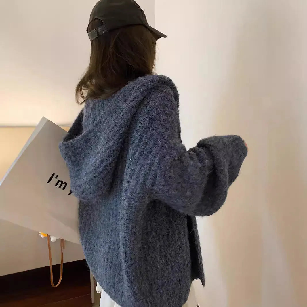 A woman's brown retro-style hooded cardigan with a loose fit, made from thick acrylic-polyester fabric.