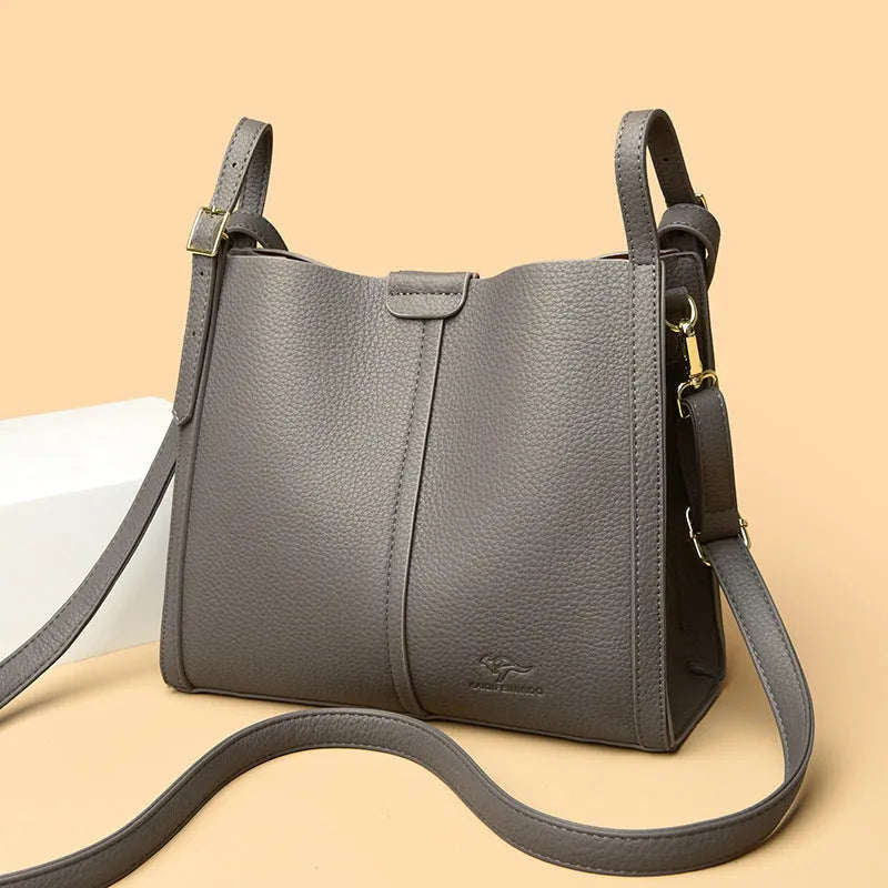 Brown retro-style ladies shoulder bag with single strap showing sewing line detailing and organisational compartments
