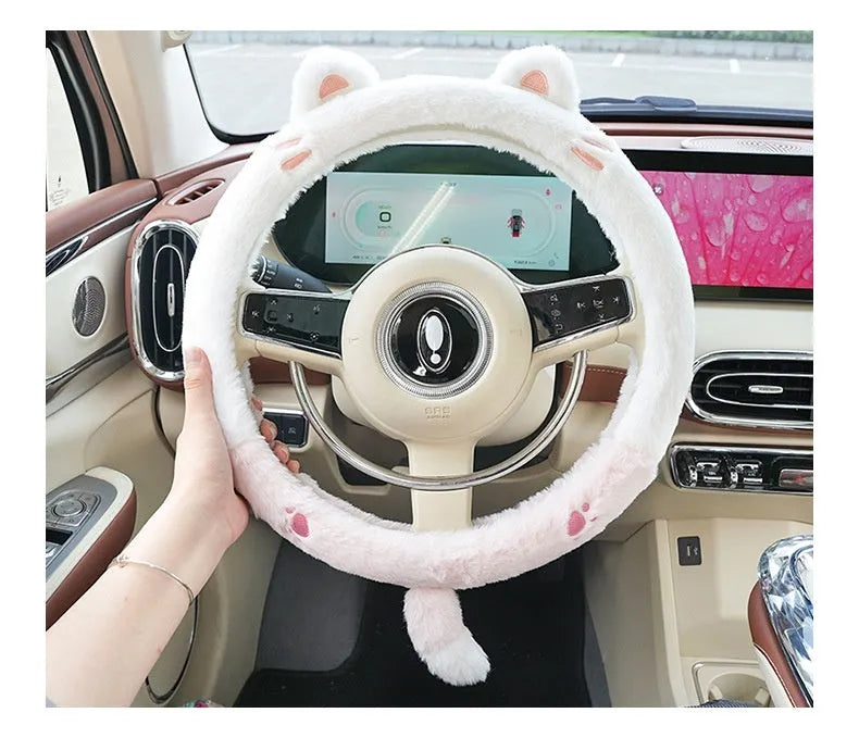 Plush rabbit fur style steering wheel cover with embroidered panda design, fitted on a car wheel