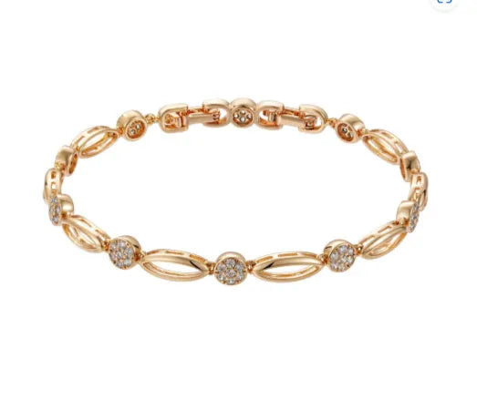 Golden hollow carved copper bracelet with U-shaped design on a wrist.
