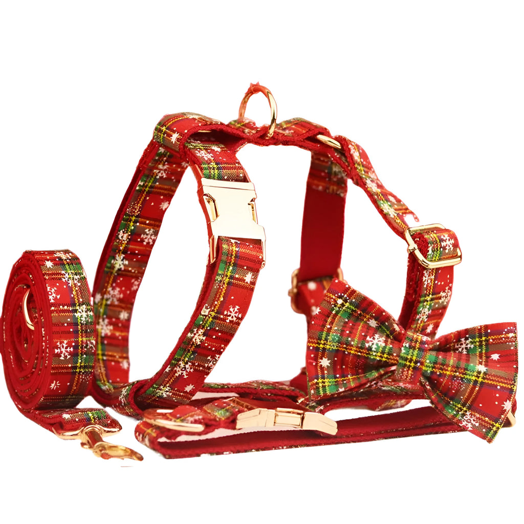 Red snowflake Christmas dog collar and leash set with plaid design and decorative bow on dog vest