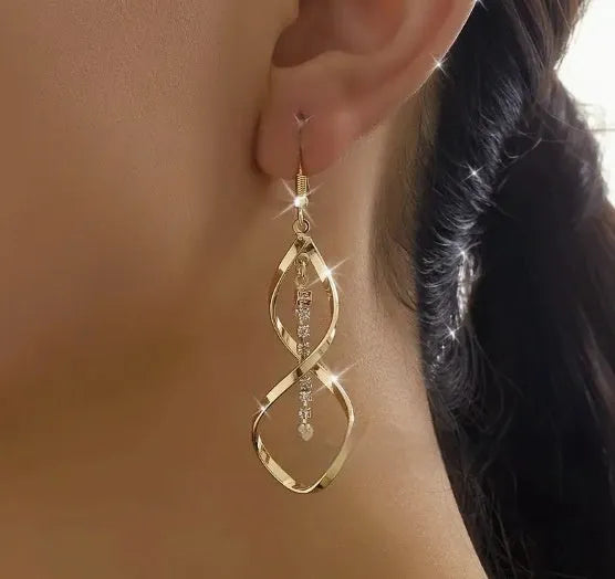 Women's gold alloy earrings with creative spiral design featuring geometric shapes and elliptical elements