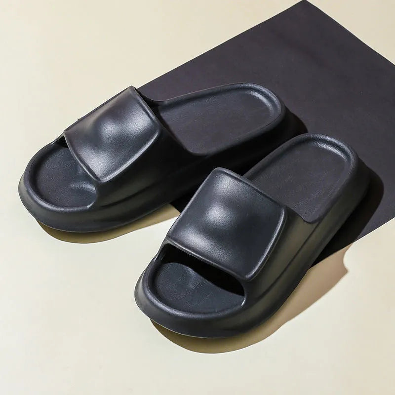 Pair of thick-soled white EVA flip-flop slippers with a non-slip patterned sole.