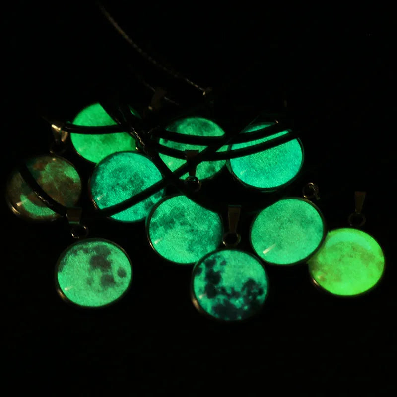 Close-up of a luminous alloy necklace with a glass pendant featuring a Christmas moon night sky and constellation design.
