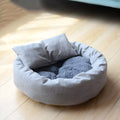 Grey round plush pet bed with removable pillow and non-slip base in four size options