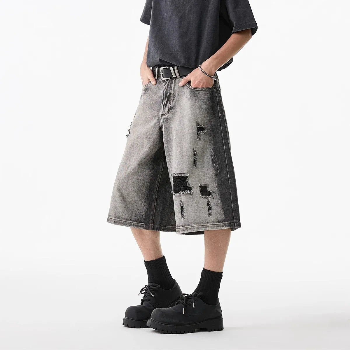 Grey women's denim shorts with water washed finish and hole distressing, loose cropped fit