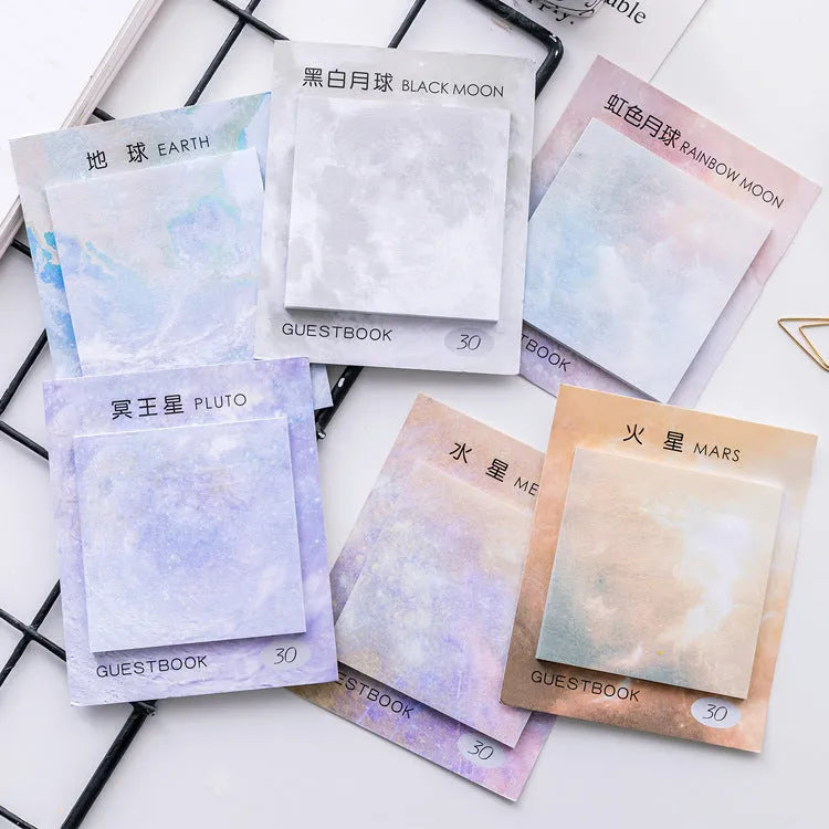 Square planet-themed sticky note pad showing oil painting designs of moon, earth, and mars.
