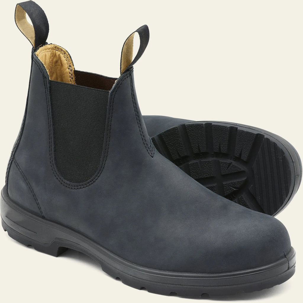Vintage grey unisex Chelsea boots on a wooden floor, showing frosted PU upper, round toe, low heel, and car stitch detail.