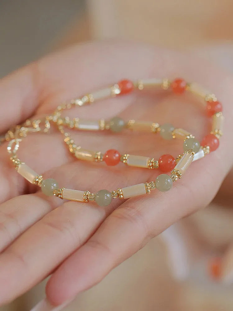 Women's bamboo joint bracelet with polished 6mm Hetian jade or South red agate beads.