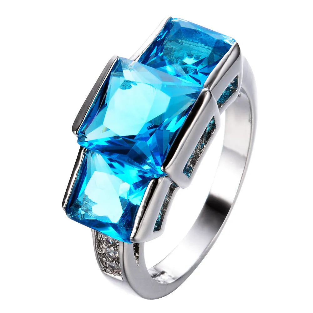 Colourful electroplated copper geometric ring on a white background, showing the metallic finish.