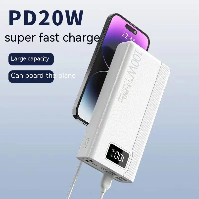 Large black and white power bank showing size comparison next to a mobile phone.