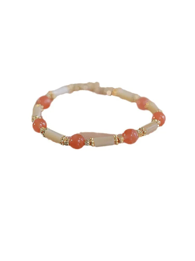 Women's bamboo joint bracelet with polished 6mm Hetian jade or South red agate beads.