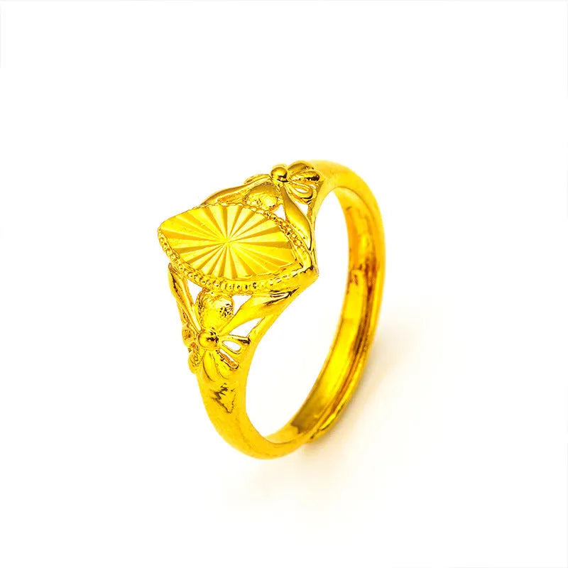 Adjustable gold-coloured brass floral ring with openwork design and textured diamond details.