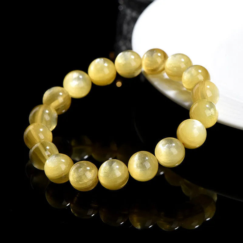 Yellow golden dragon mica bracelet with polished round geometric beads on wrist
