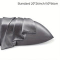 A pair of solid colour satin cloth pillowcases in a choice of sizes on a bed.