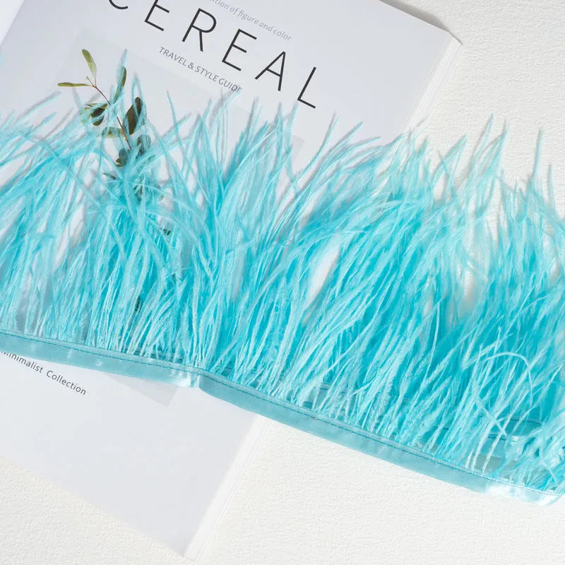 Decorative feather cloth strip in multiple colours including white, black, and mint green for DIY clothing and craft projects