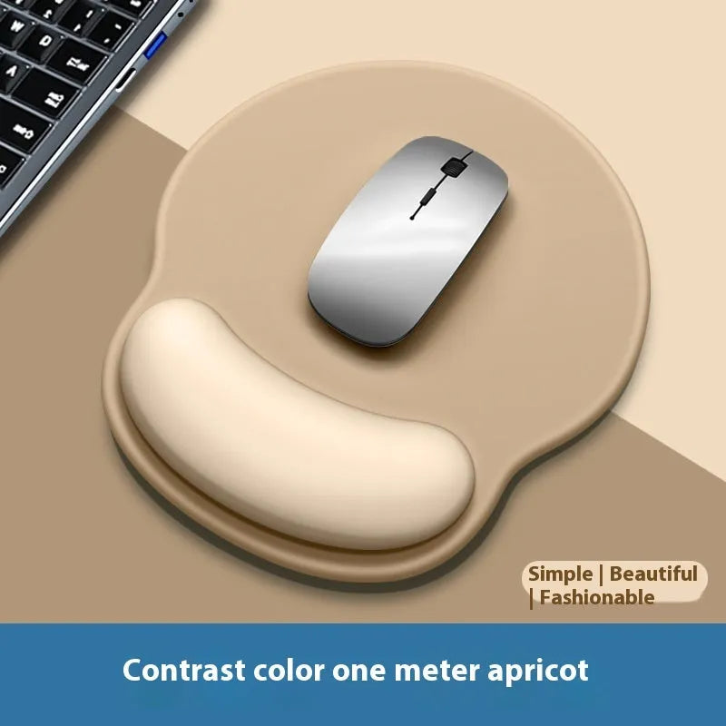 Silicone mouse mat with integrated wristband pad in a solid colour on a desk.
