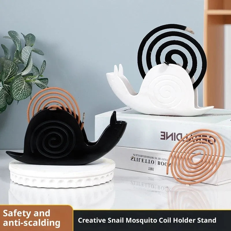 Black plastic universal mosquito incense holder on a table, simple portable design with creative animal style
