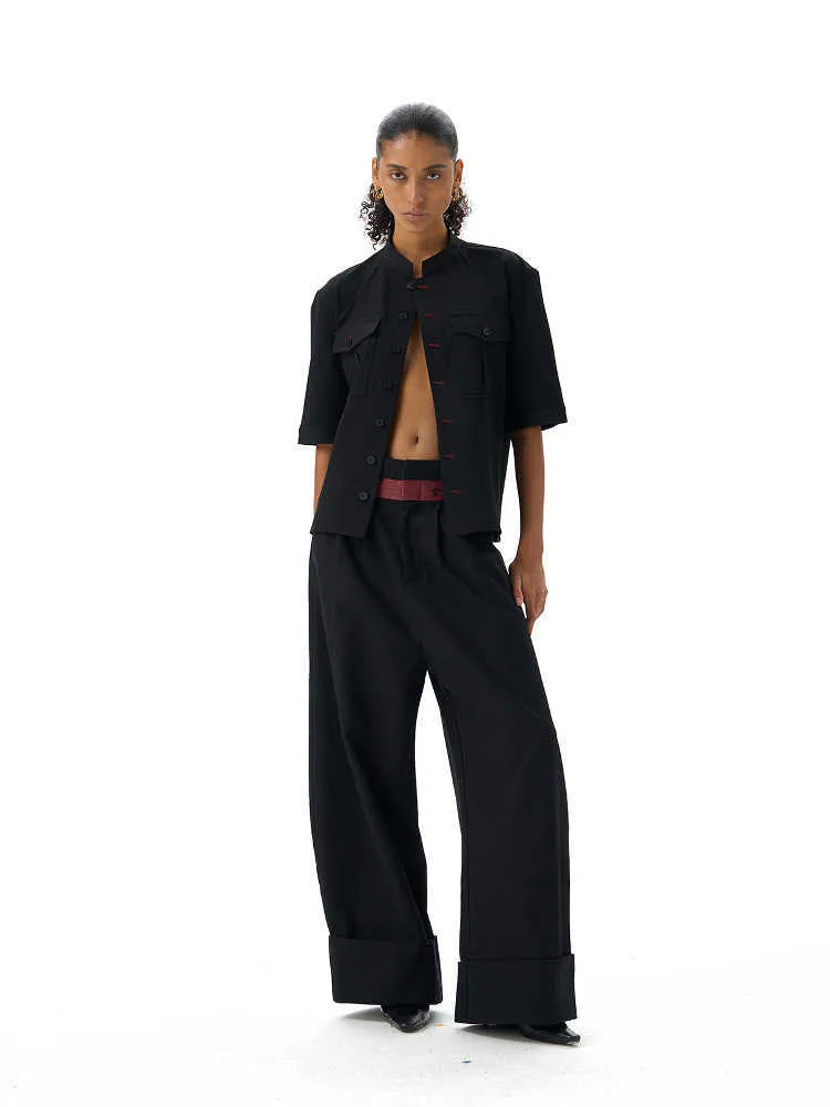 Black loose-fit half-sleeve hunting shirt with a shirt collar on a hanger.
