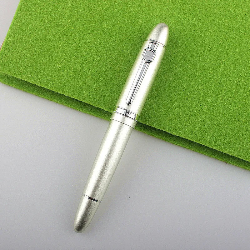 Metal ball pen with pearl beads, black body and silver clip, lying on a desk