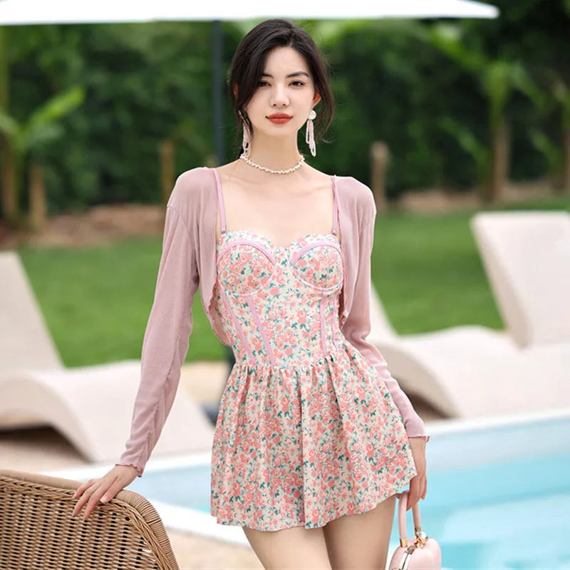 Women's pink floral jumpsuit swimsuit with adjustable suspender straps on mannequin