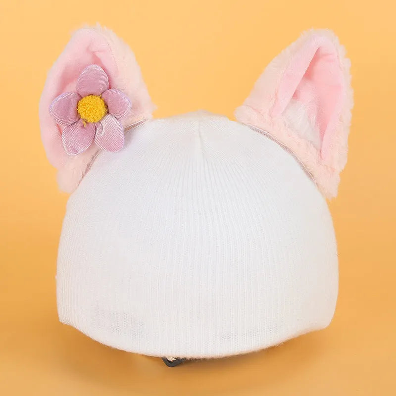 Soft plush cartoon character cover stretched over a pair of black on-ear headphones.