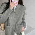 Beige viscose fibre sweater coat cardigan with long sleeves laid flat.