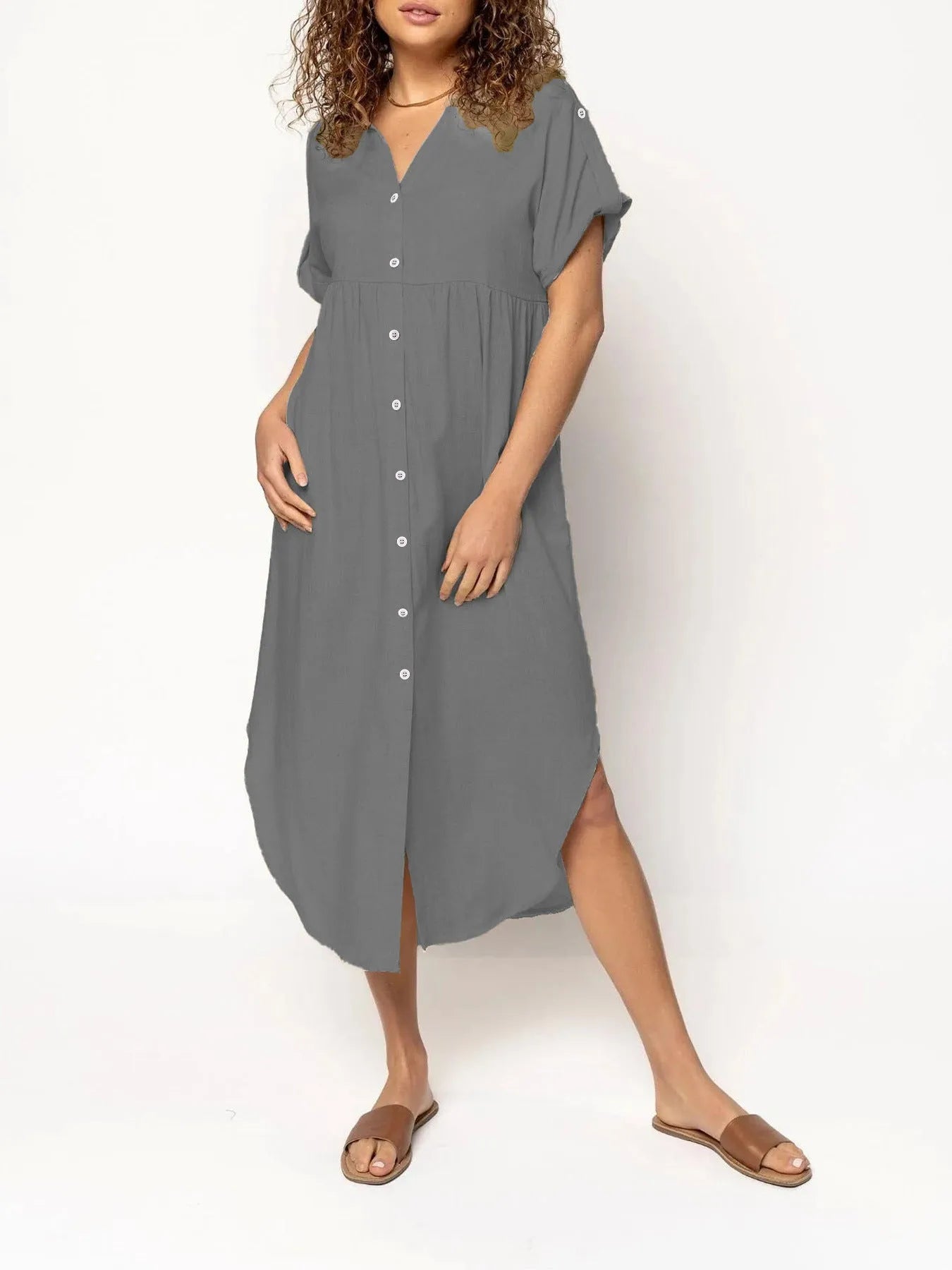 Loose fit casual midi dress with button front in solid colour on a model