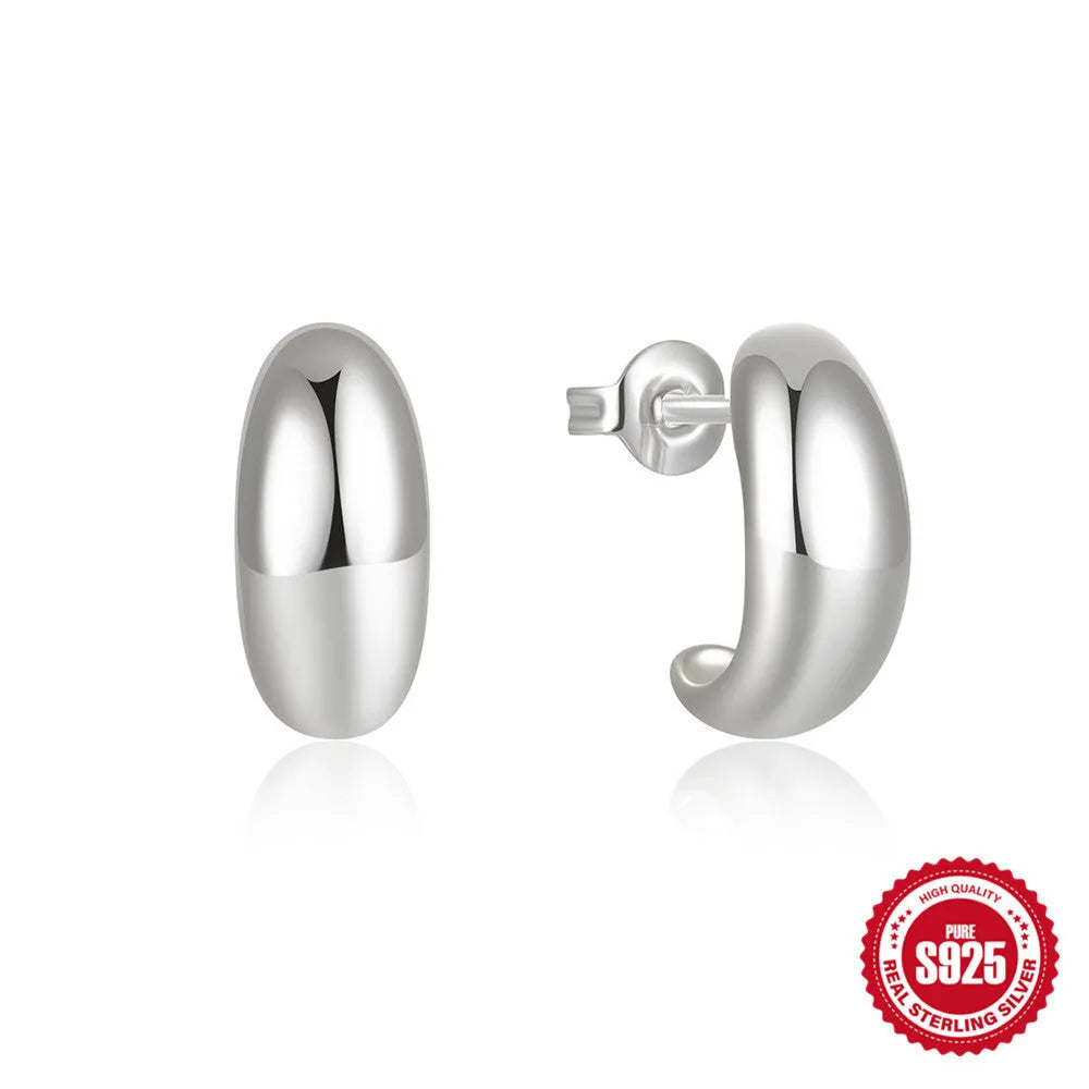 C-shaped sterling silver stud earrings with glossy electroplated finish in gold colour
